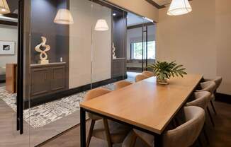 A conference room with a long table and chairs.
