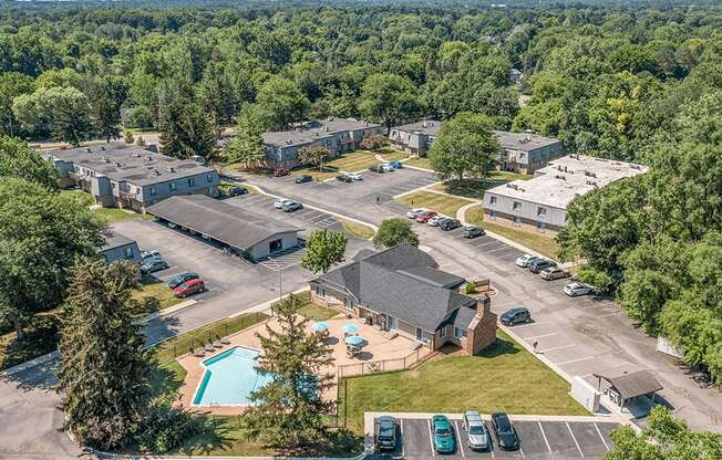 A bird's eye view of a residential complex with a swimming pool.