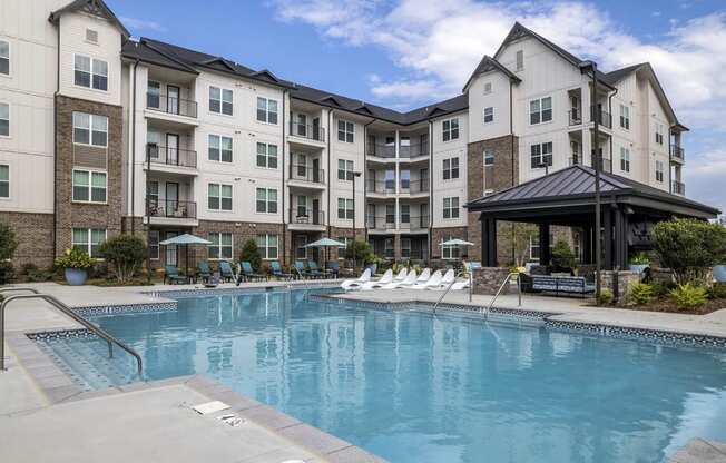 a swimming pool in front of an apartment building
