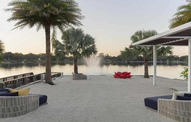 a dock with palm trees and a fountain  and a lake at Lakeside Villas, Orlando Florida
