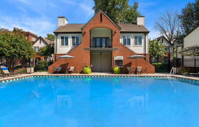 A house with a pool in front.