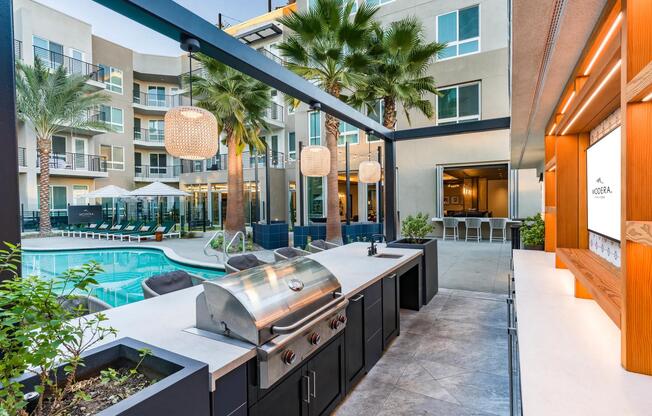 Modera Pomona features a grilling area near the pool, perfect for outdoor meals and relaxation.