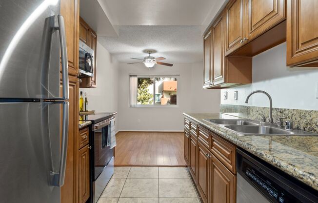 a kitchen with stainless steel appliances and wooden cabinets