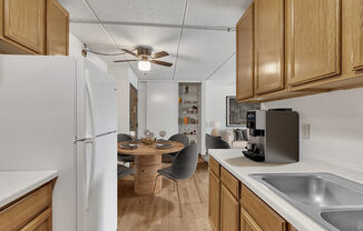 a kitchen with a dining table and a refrigerator