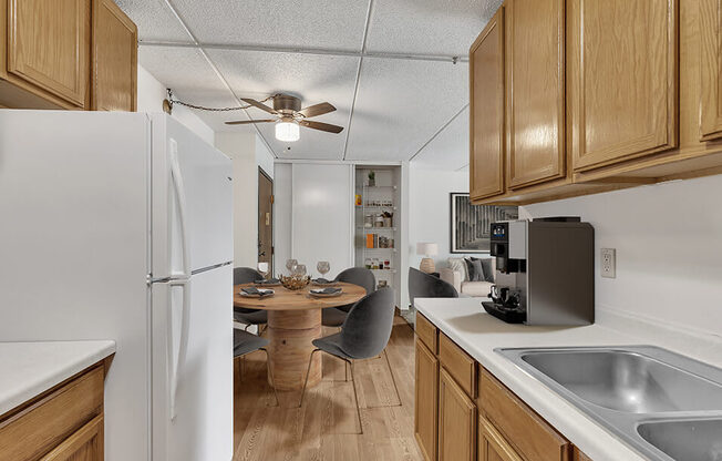 a kitchen with a dining table and a refrigerator