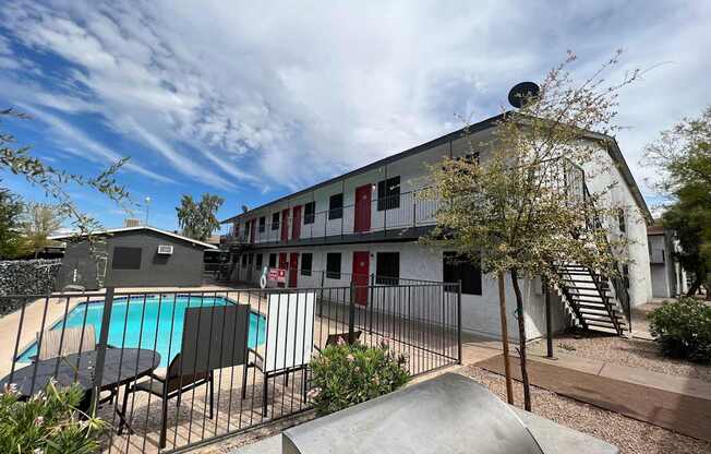 A large building with a pool in front of it.