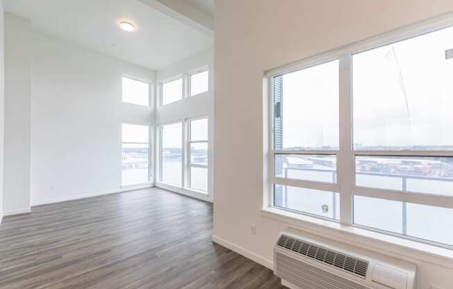 Harbor Sky Living Room with Large Windows and Private Balcony