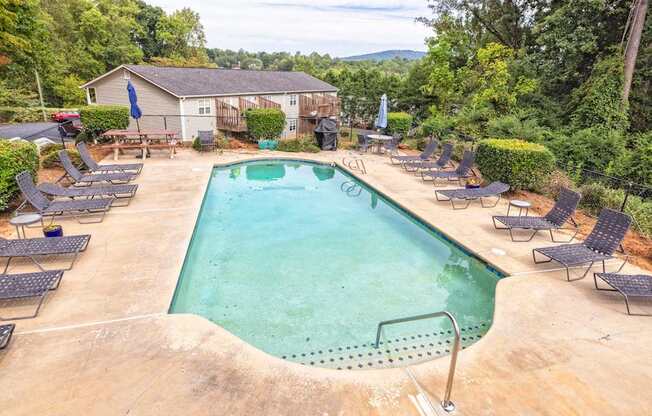 A large outdoor swimming pool surrounded by lounge chairs.