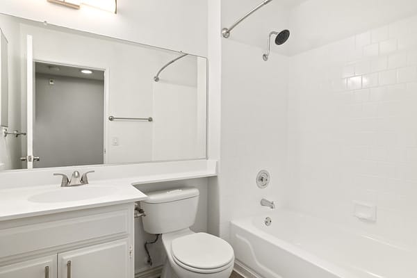 a white bathroom with a sink toilet and a tub at NOHO GALLERY Apartments, North Hollywood at NOHO GALLERY Apartments, North Hollywood 