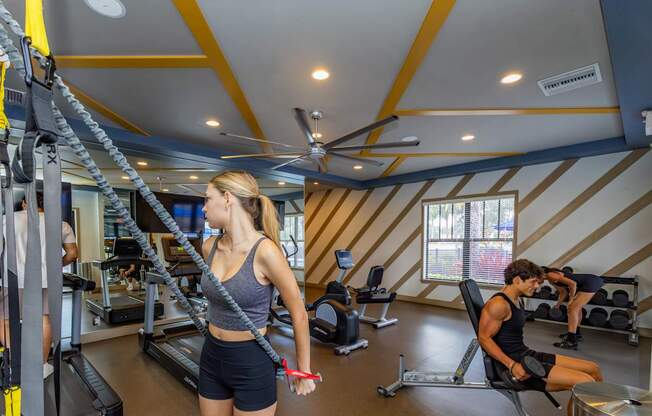 A woman is working out on a treadmill in a gym.