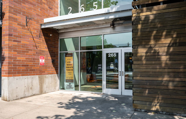 the entrance of a building with glass doors and a sign in the window