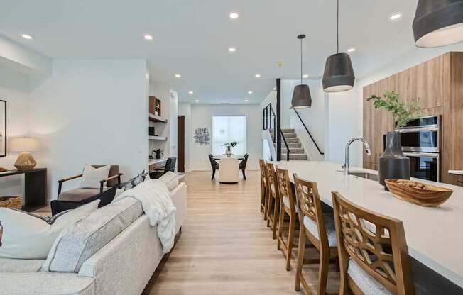 a living room with a kitchen and a dining room