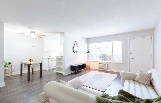 a living room with a white couch and a large window