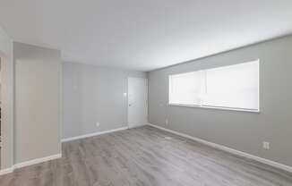 a bedroom with hardwood floors and grey walls