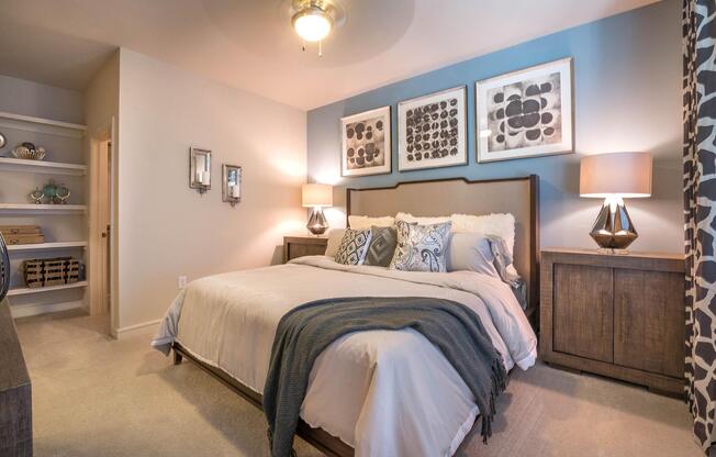 a bedroom with a bed and desk in a room