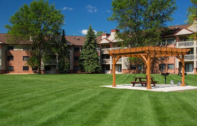 Large manicured lawn with a sun terrace over a park bench