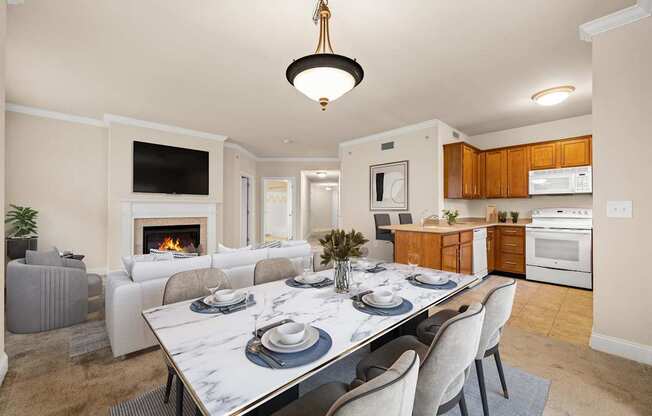 A modern dining room with a marble table and grey chairs.