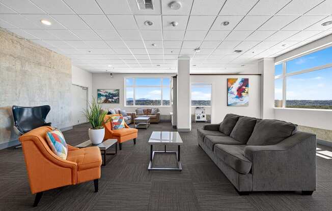 A living room with a grey couch, orange armchair, and a coffee table.