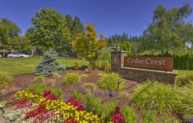 Apartments in Beaverton OR - Cedar Crest - Front Entrance Sign Surrounded by Lush Landscaping