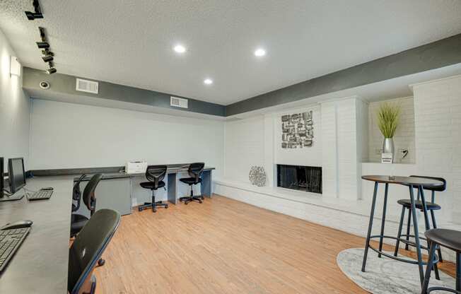 a living room with a fireplace and a bar with stools