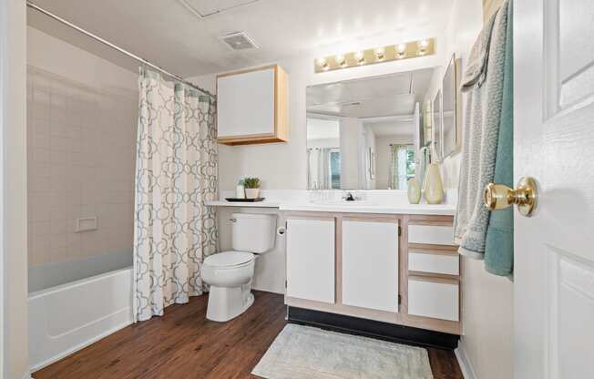 a bathroom with a toilet sink and bathtub in a 555 waverly unit