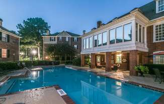 a large swimming pool in front of a brick building with a pool house and a at Madison Brookhaven, Atlanta, GA, 30329