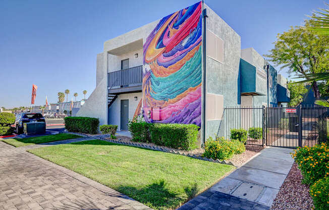 A modern house with a colorful mural on the side.