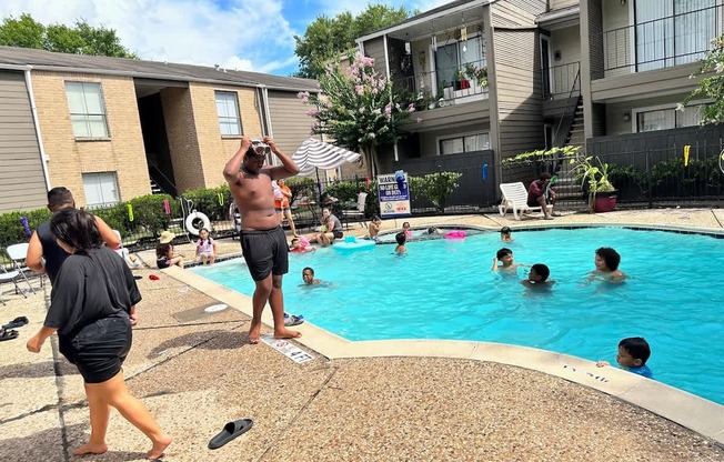 A group of people are enjoying a sunny day at a pool.