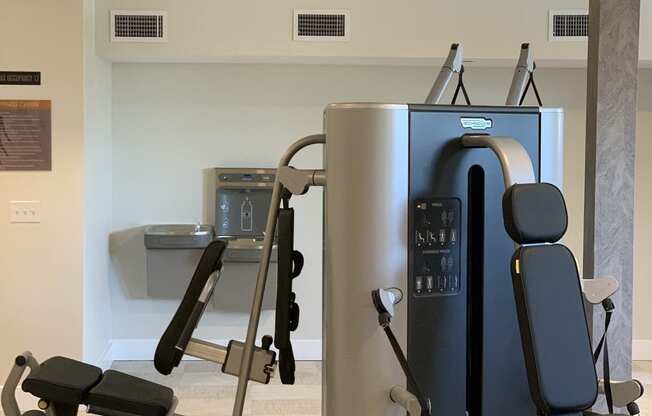 Fitness Center with Chest Machines, Water Fountain, Rules Sign