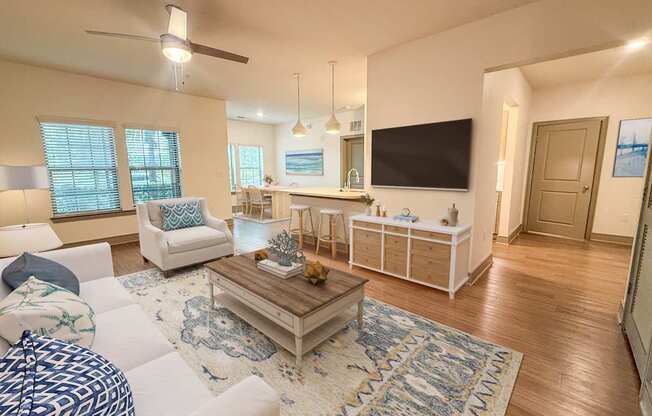 A living room with a white couch and a coffee table.