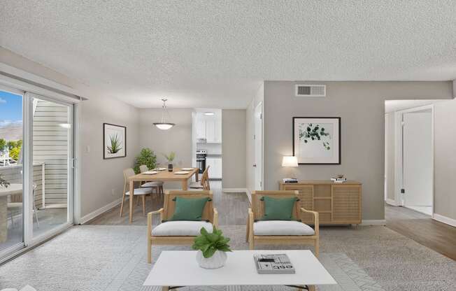 an open living room and dining room with a sliding glass door to a balcony