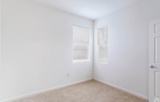 A room with a carpet floor and two windows at Cornerstone at Gale Ranch Apartments, San Ramon 94582