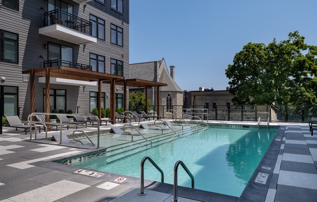 Luxurious resort-style pool courtyard with lounge areas.