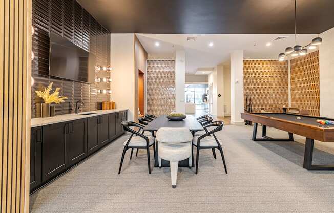 A modern clubhouse room with a table set for four.