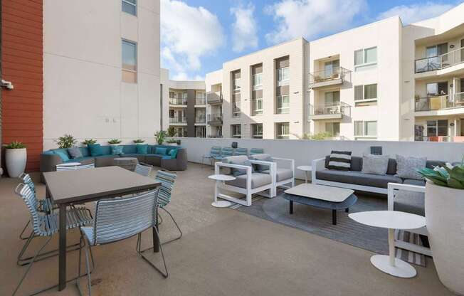 A patio with furniture and a table with a white background.