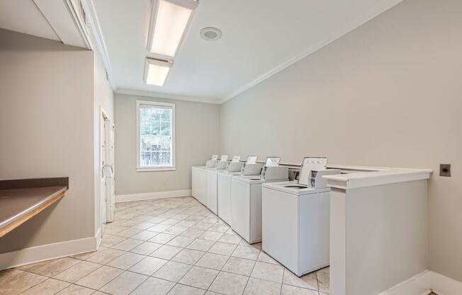 a washer and dryer room in a home with washers and washing machines