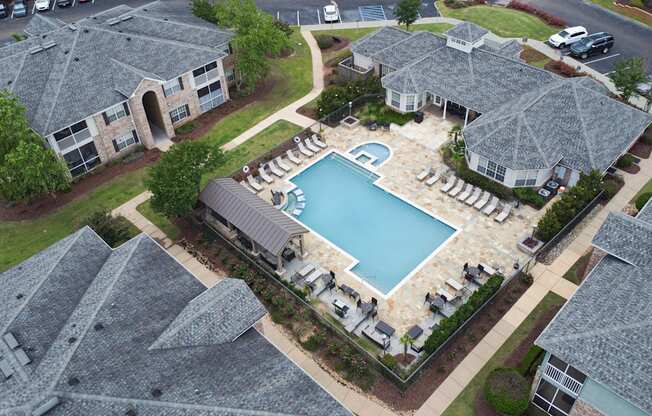 an aerial view of a swimming pool in a home with umbrellas