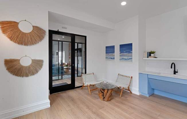 A modern living room with a wooden floor and a blue sofa.