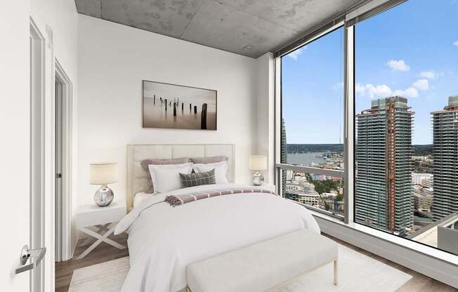 A bedroom with a large bed and a view of the city.