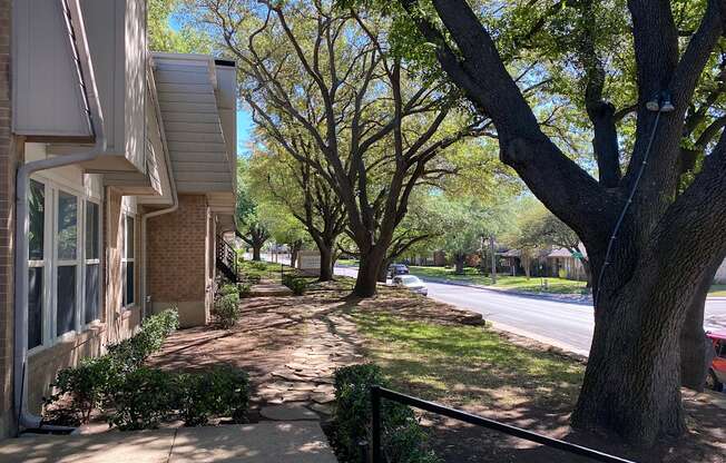 This is a photo of building exteriors and the grounds at Woodbridge Apartments in Dallas, Texas.