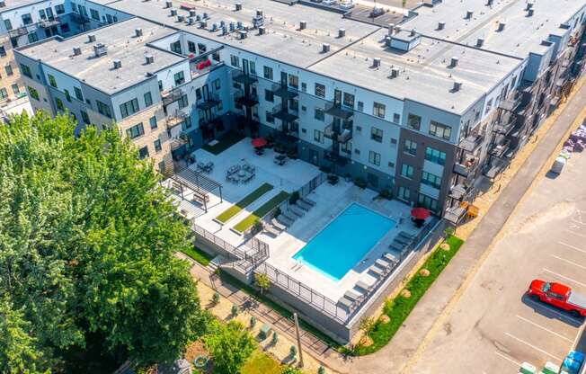 an aerial view of an apartment building with a blue pool