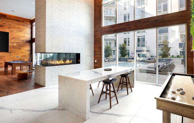 Clubroom with firepit, billiards table, and shuffle board