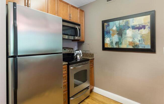 Kitchen with Brown Cabinets Stainless Steel Appliances and Grey Counters and Breakfast Bar with Decorative Items