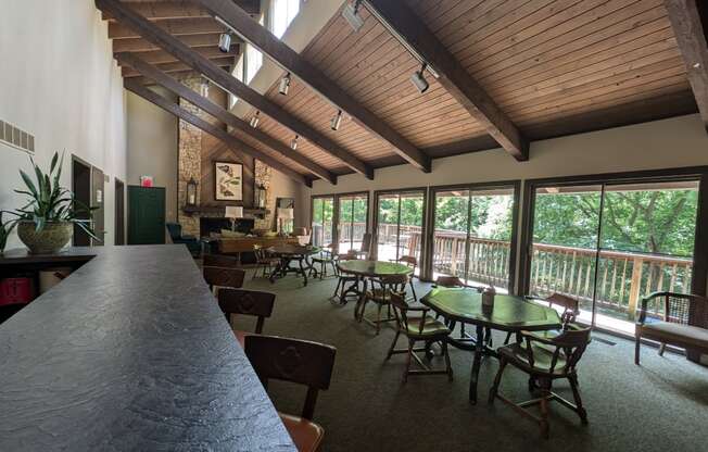 a dining room with tables and chairs and large windows