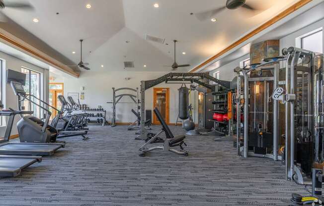 A spacious gym with a variety of equipment including treadmills, weights, and exercise machines.