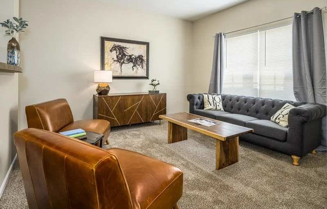 a living room filled with furniture and a large window