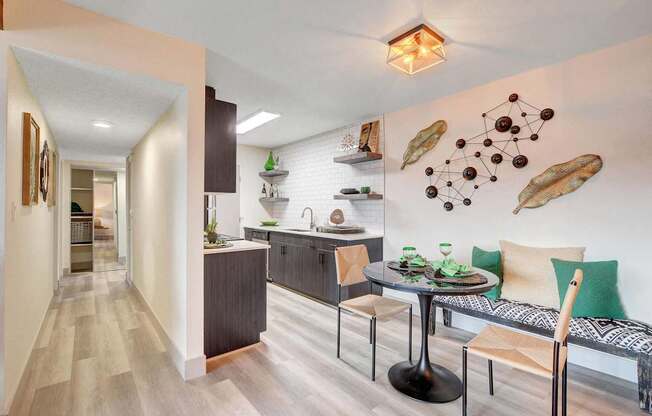 A modern kitchen with a dining table and chairs.