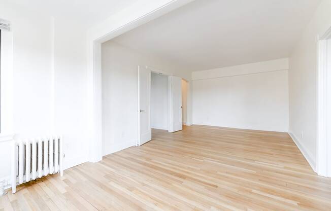 vacant living area with hardwood flooring at the dahlia apartments in washington dc