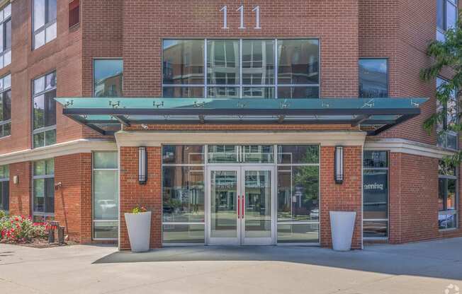 the entrance to a brick building with glass doors