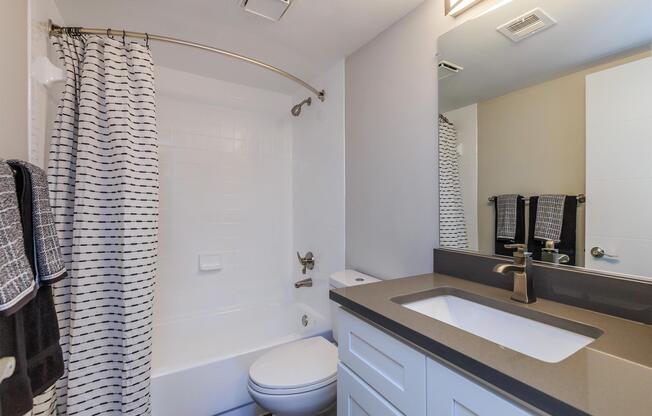 a white sink and a mirror